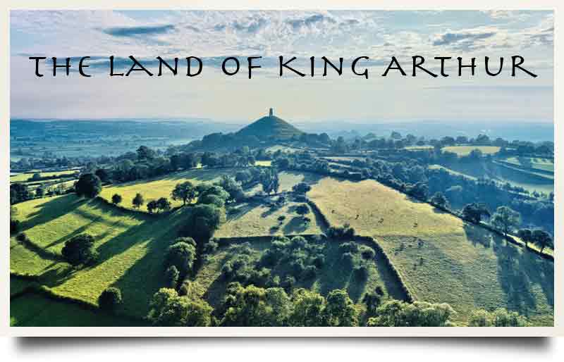Picturesque landscape with the Tor and caption 'The Land of King Arthur'.
